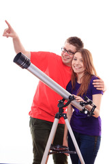 Man and woman watching the stars through a telescope