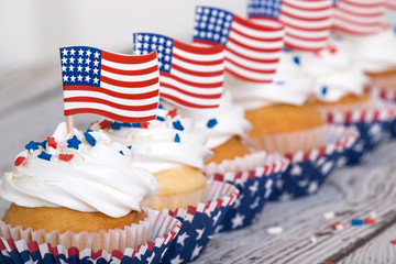 Row of patriotic cupcakes with sprinkles and American flags