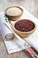 Brown and white raw rice, chopsticks