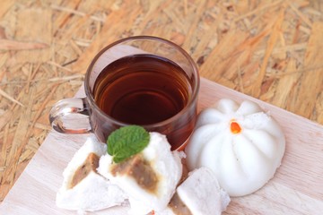 steamed pork buns, chinese dim sum and hot tea