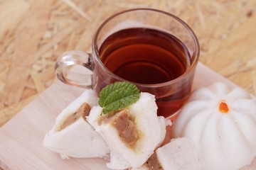 steamed pork buns, chinese dim sum and hot tea