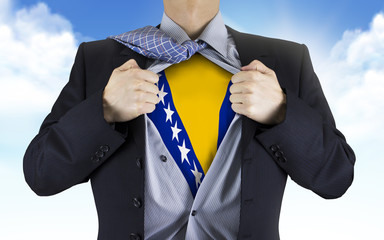 businessman showing Bosnia and Herzegovina flag underneath his s