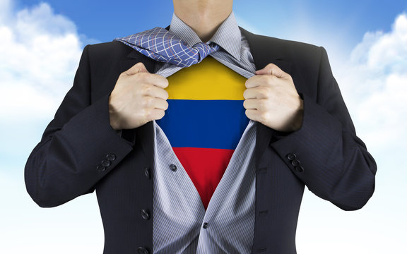 businessman showing Colombia flag underneath his shirt