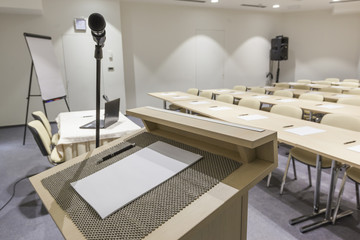 Speaker's stand and microphone in modern classroom