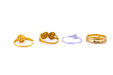 Collection of gold and silver rings over white background