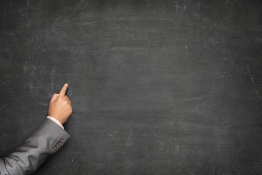 Blank blackboard with businessman hand pointing