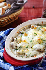 Mushrooms with cheese sauce in a baking dish