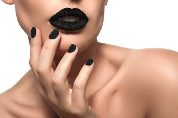 Beautiful female model with black caviar on his lips