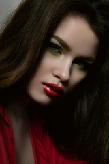 Fototapeta premium Beauty fashion female model with red lips and red blouse