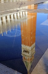 Puddle with reflection of the campanile di St Mark in Venice Ita