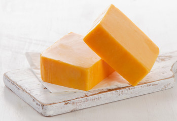 Cheddar Cheese on a Cutting Board