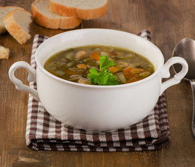 Bowl of Soup with Lentils, Beans, Chicken and Vegetables on a ru