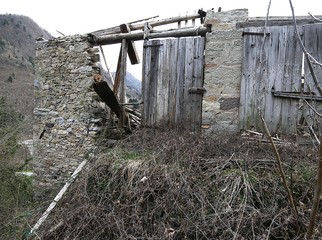 Ancient House in ruins with the roof destroyed in the mountains