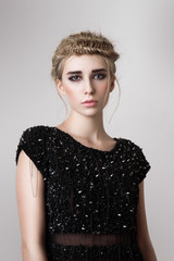 Fashion blonde model with black dress