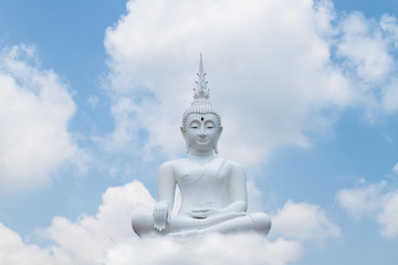 Fototapeta na wymiar White buddha status on blue sky