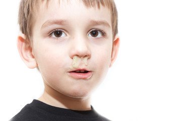 ill boy with flu and green rhinitis at nose - isolated image