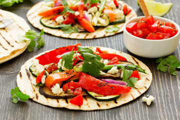 Vegetarian snack tacos with grilled vegetables and salsa.