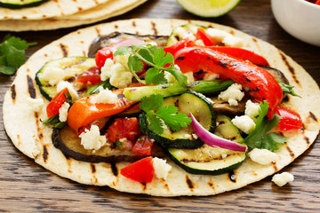 Vegetarian snack tacos with grilled vegetables and salsa.