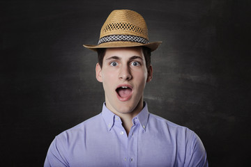 amazed young man over grey background