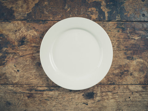 White plate on wooden table