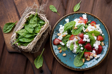 Top view of strawberry, spinach leaves and cheese salad