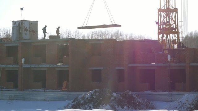Building workers at construction site doing concrete works with