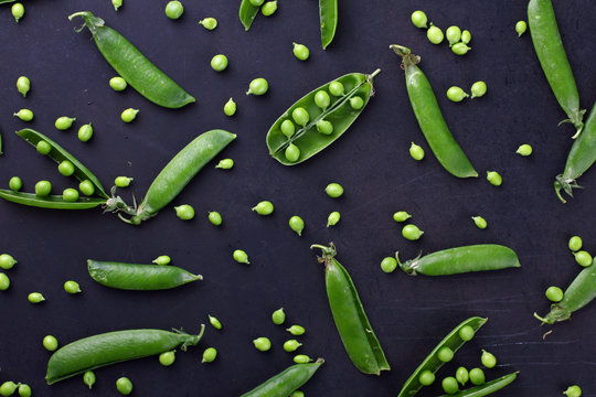 Fresh green peas on a black background