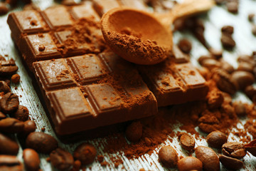 Still life with chocolate, grains and cocoa on wooden background