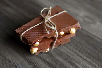 Stack of tied chocolate on wooden background