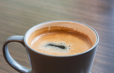 Cup of coffee on wooden table