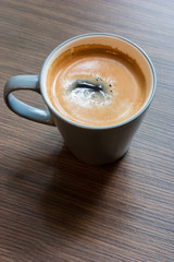 Cup of coffee on wooden table