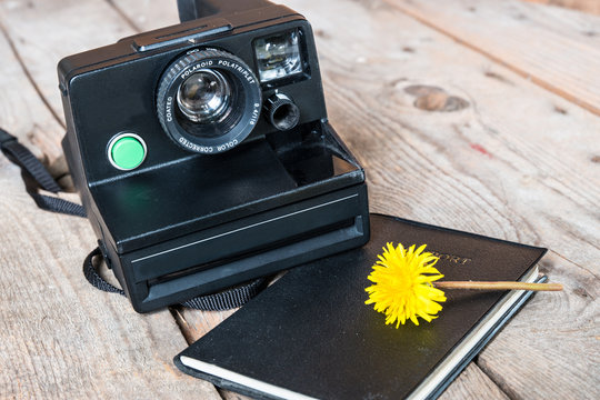 Travel concept-vintage old Polaroid Camera with passport