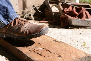 Worker steps on nail outdoors