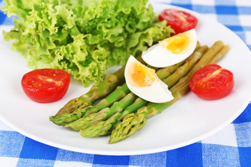 Plate of dietary salad with boiled asparagus and egg, closeup