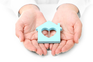 Female hands holding house, closeup