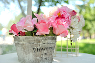 Bouquet of beautiful artificial flowers wooden basket