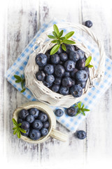 Blueberry basket and jug on white wooden table
