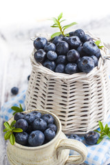 Blueberry basket and jug on white wooden table
