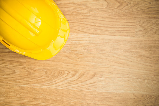 Yellow Industrial Protective Helmet On Wooden Background