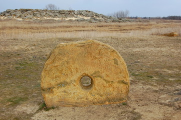 Round megalithic stone in the steppe. 