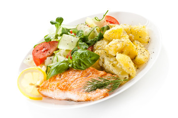 Fried salmon and vegetables on white background 
