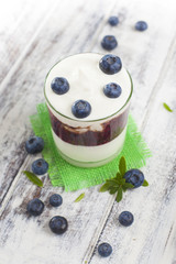 Obraz na płótnie Canvas Glass of yogurt with fresh blueberries