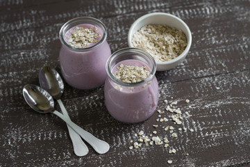 smoothie with strawberries and oat flakes in a glass jar 