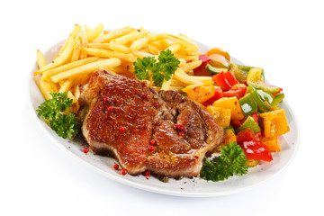 Grilled steak, French fries and vegetables 