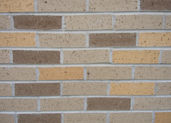 New bricks of various shades of brown make up this new brick wall building.