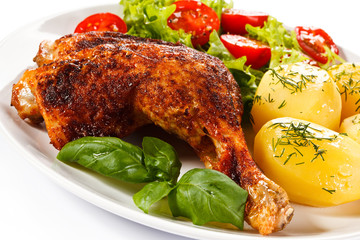 Barbecued chicken leg with boiled potatoes and vegetables