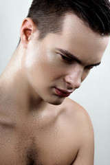 Fashion male model with drops on face