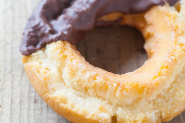 Old fashion chocolate donut on wood background