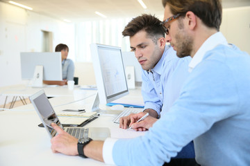 Businessmen in work meeting with laptop computer