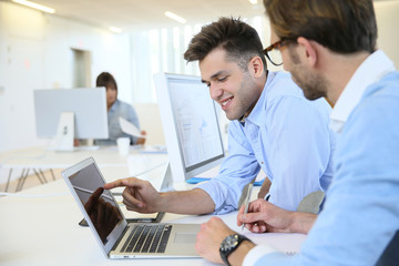 Businessmen in work meeting with laptop computer